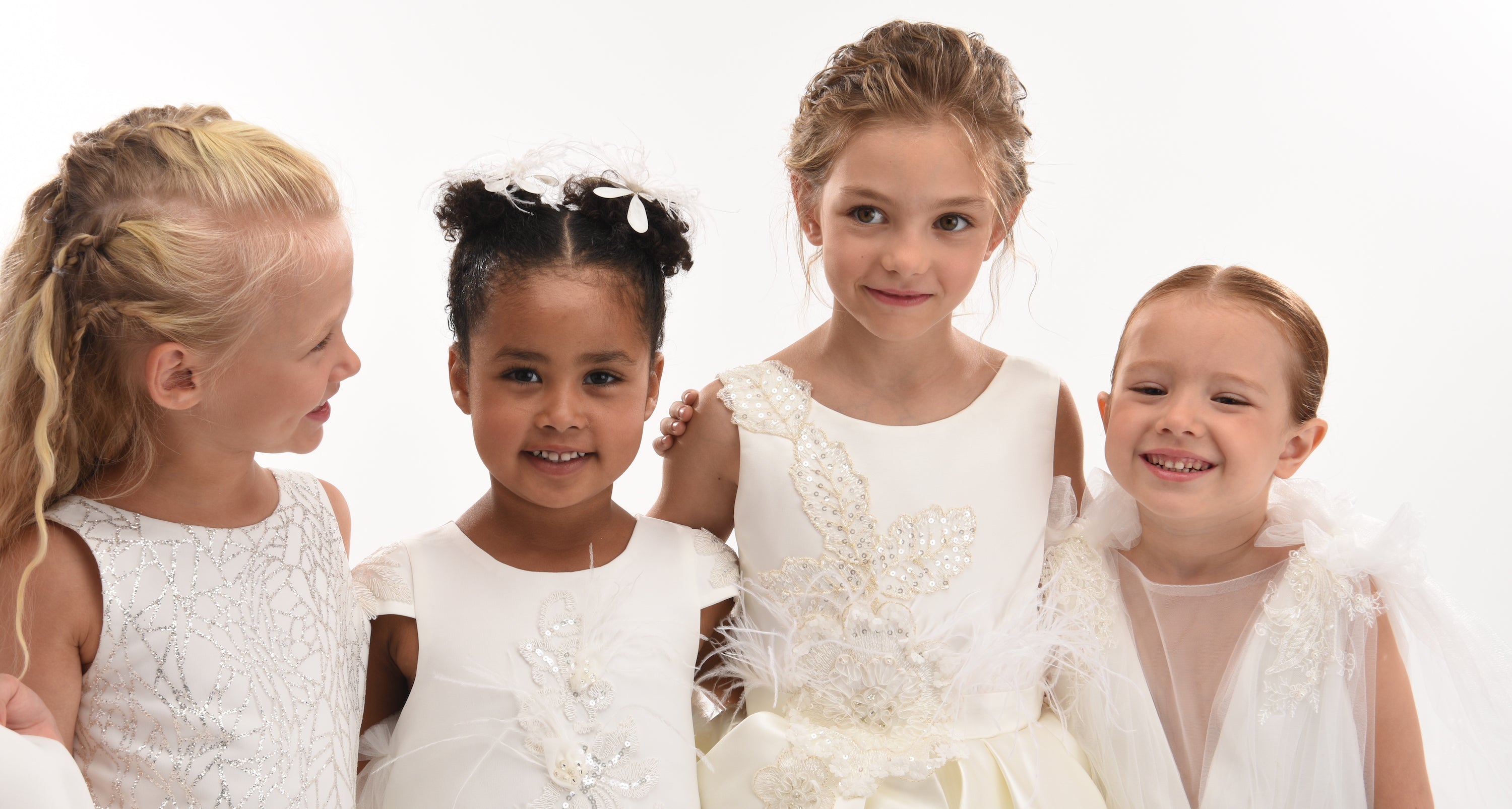 4 beautiful girls posing in Tulleen white flower girl dresses