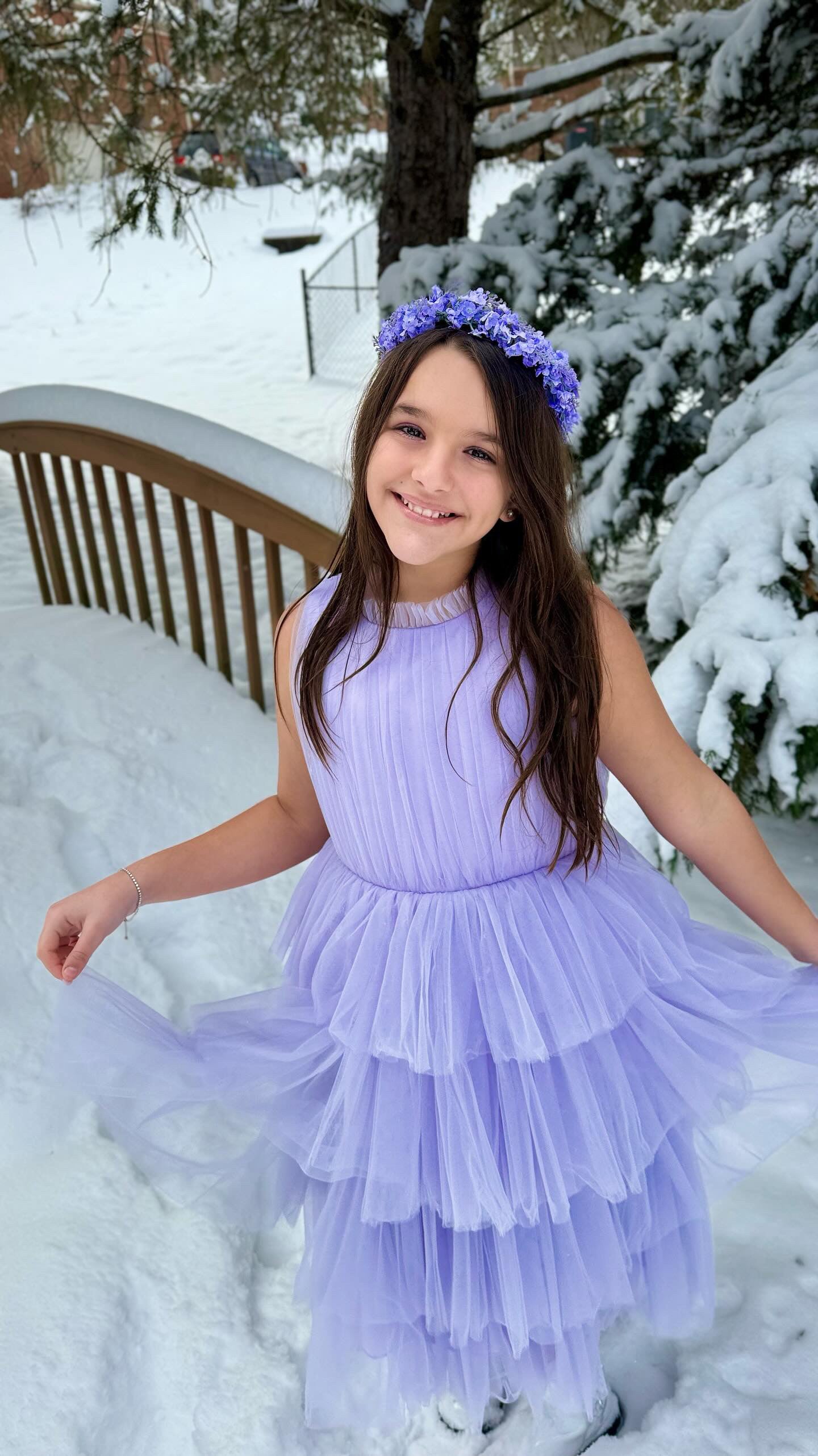 Girl wearing purple tulleen dress in the snow